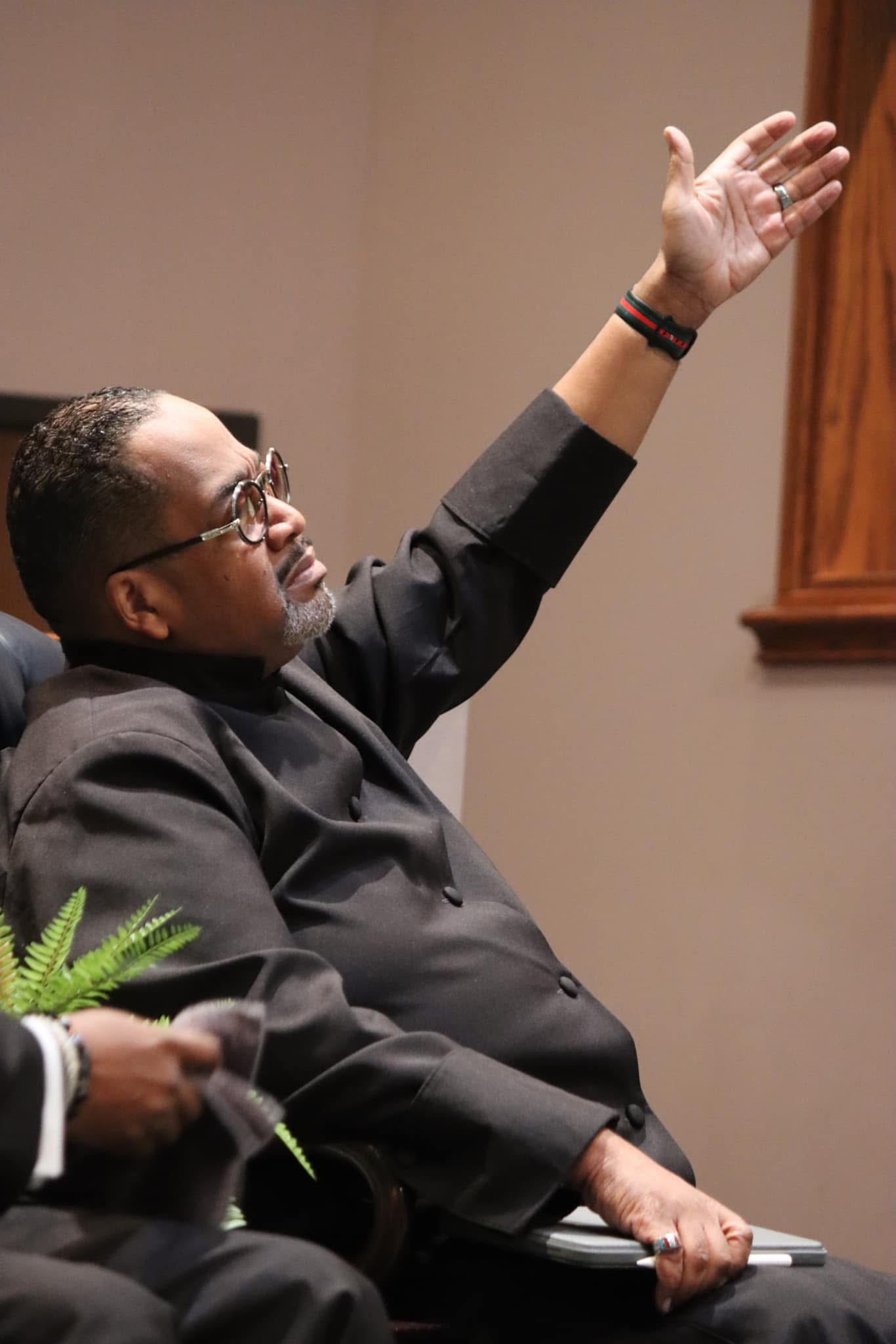 Dr. Brown worshipping during service