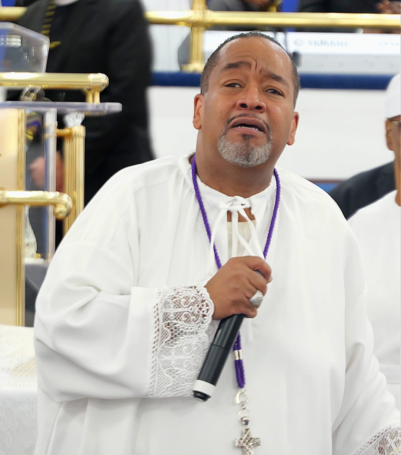 Dr. Brown ministering with microphone in hand